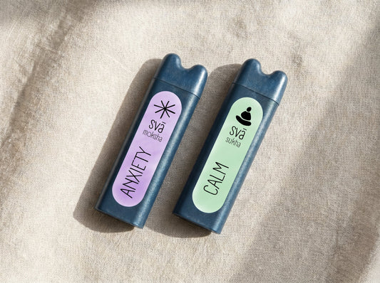 Two svāroma aromatherapy inhalers on linen -- calm and anxiety blends compared
