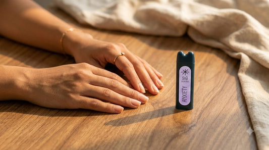 hands resting on a desk near a svāroma aromatherapy inhaler before a meeting, warm natural light