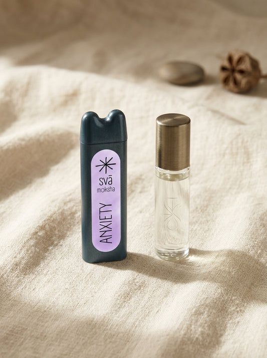 A Svāroma aromatherapy inhaler and an unbranded glass roll-on bottle resting side by side on a soft natural linen surface in warm morning light, styled in a minimal, premium editorial composition.