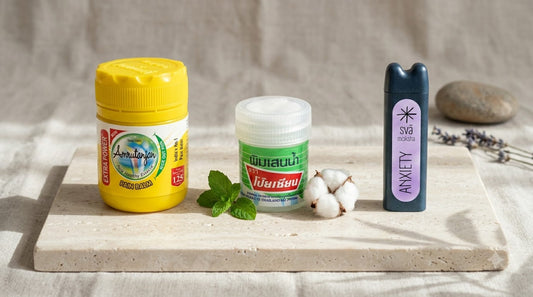 traditional nasal inhalers (amrutanjan, poy-sian) side by side on slate, comparing traditional menthol inhalers with a Svaroma aromatherapy inhaler