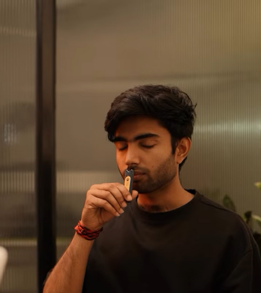 Employee using a svaroma inhaler to regulate nervous system while stressed at work