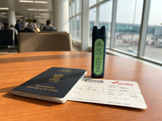 svā aaro(Svaroma nausea) aromatherapy inhaler for travel nausea in an open bag beside a passport, warm natural light