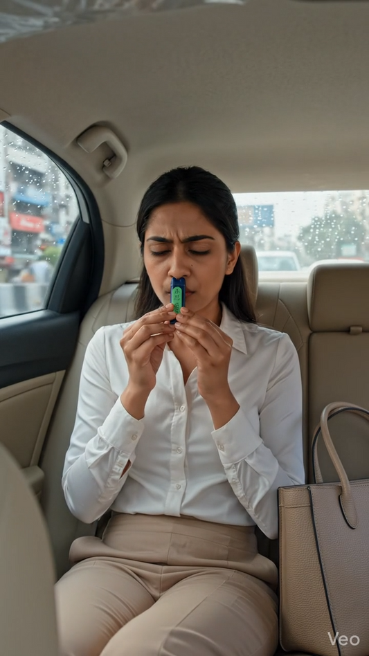 A modern Indian woman using the Svaroma nausea inhaler to help recover from motion sickness while driving to work