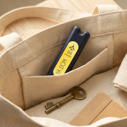 svā sawadee (Ya Dom) Thai inhaler tucked into a bag, a portable essential oil inhaler for travel and commutes